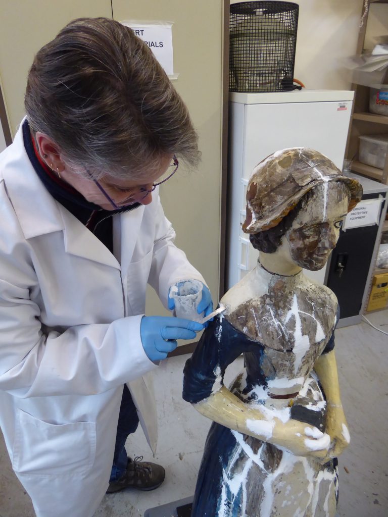 wooden statue of a girl - during conservation treatment