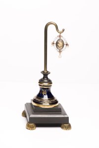 A 19th century jewel containing a lock of Charles 1st's hair, on a stand.